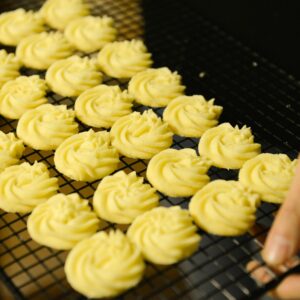 Freshly baked homemade butter cookies cooling on a rack, perfect for dessert lovers.
